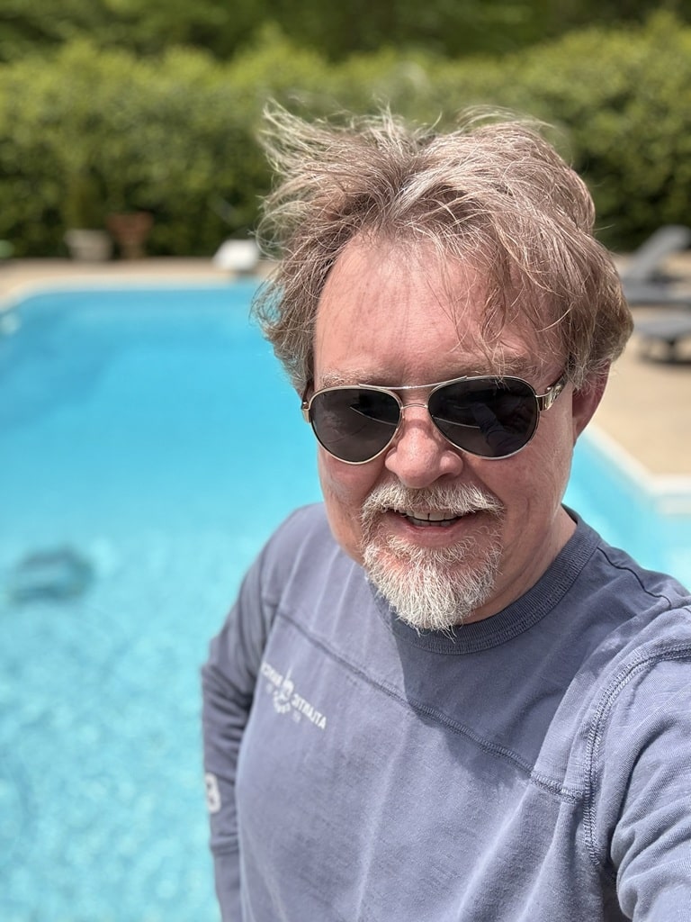 Greg cleaning the swimming pool