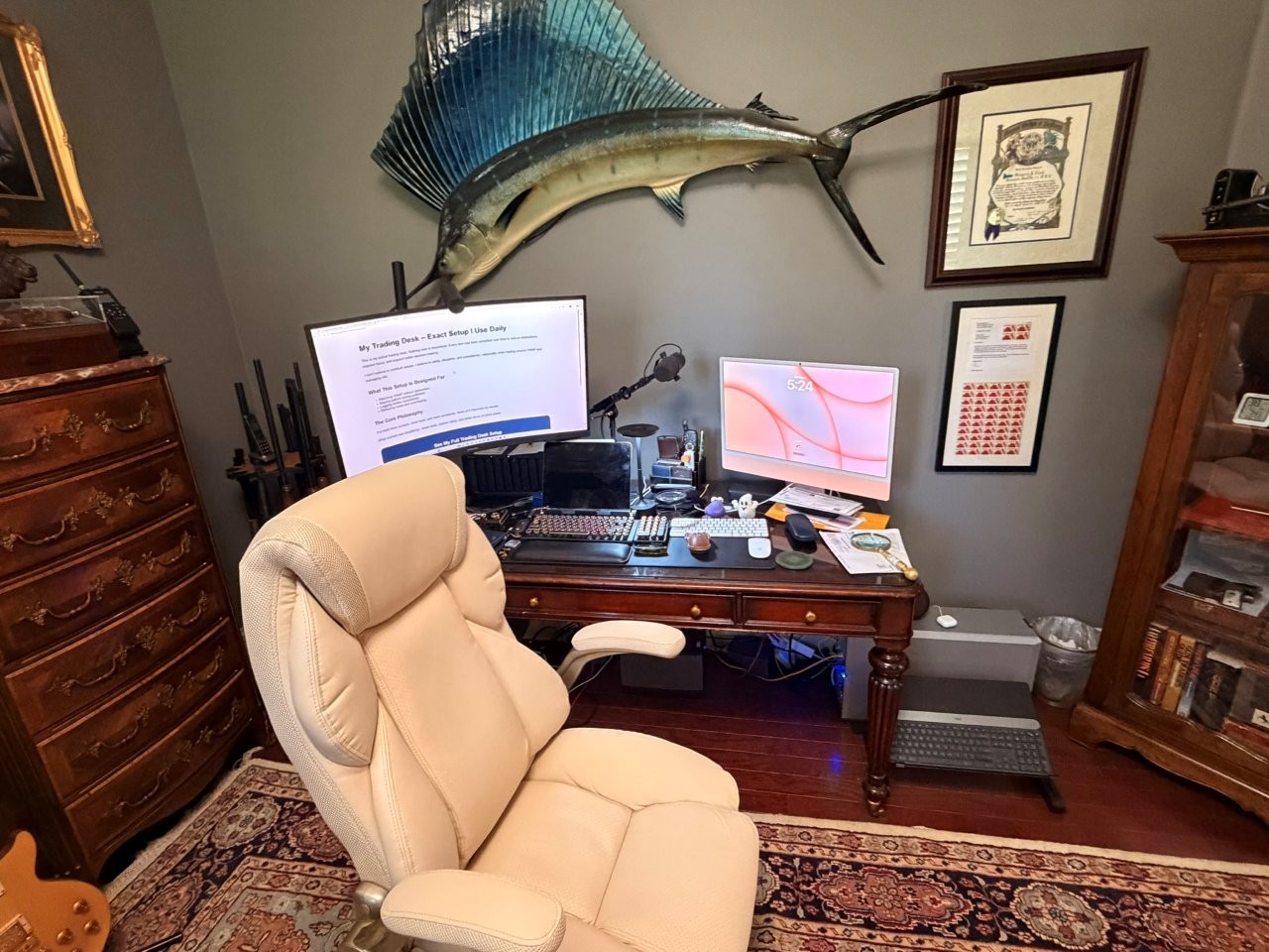 Greg Cook's trading desk setup with chair, large monitor, iMac, keyboard, and workspace